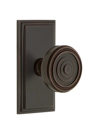 Grandeur Carre Rosette Door Set with Soleil Knobs in Timeless Bronze.